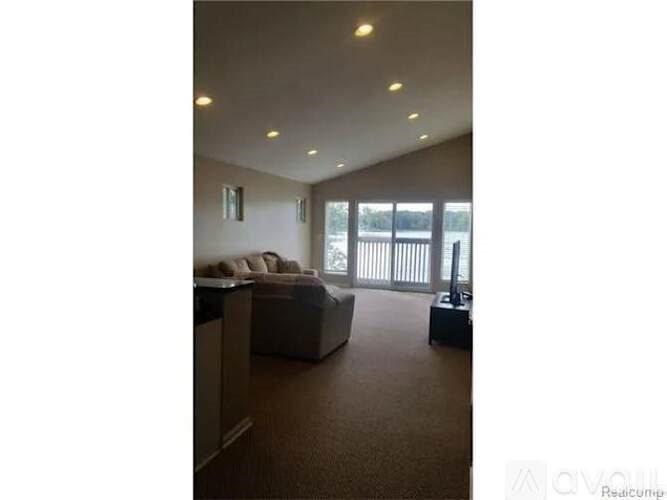 A living room with a couch and a television.