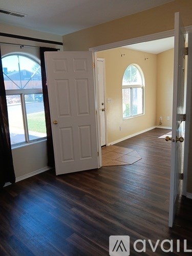 A room with a white door and a window.