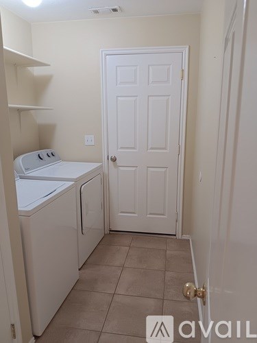 A small laundry room with a washer and dryer.