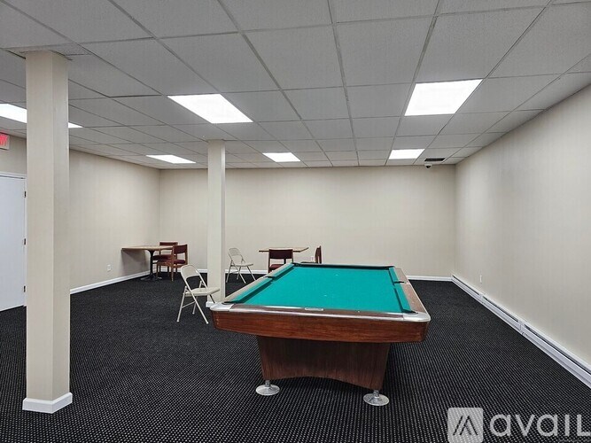 A pool table is in the middle of the room.