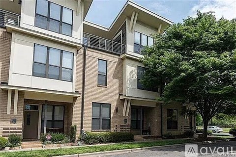 Apartment building with a tree in front.