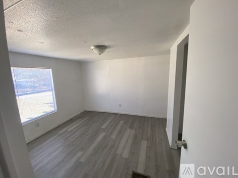 A room with a window and a door.