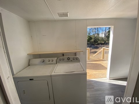 A small laundry room with a washer and dryer.