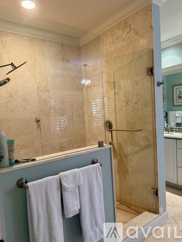 A backyard with a pool and patio furniture.