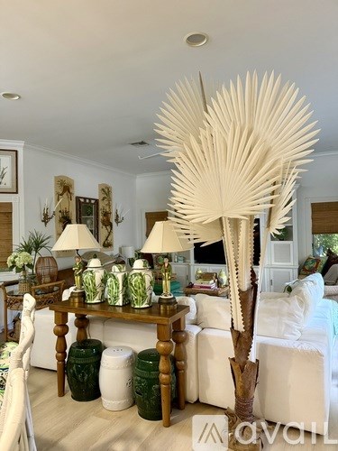 A room with a white palm tree decoration in the middle.