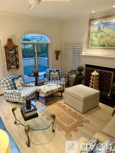 A room with a table, chairs, and a painting on the wall.