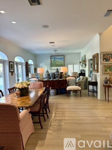 A dining room with a wooden table and chairs.