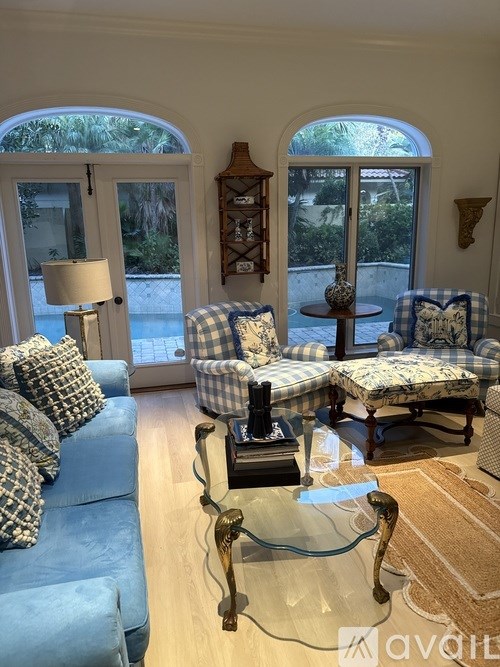 A living room with a white couch and a green side table.