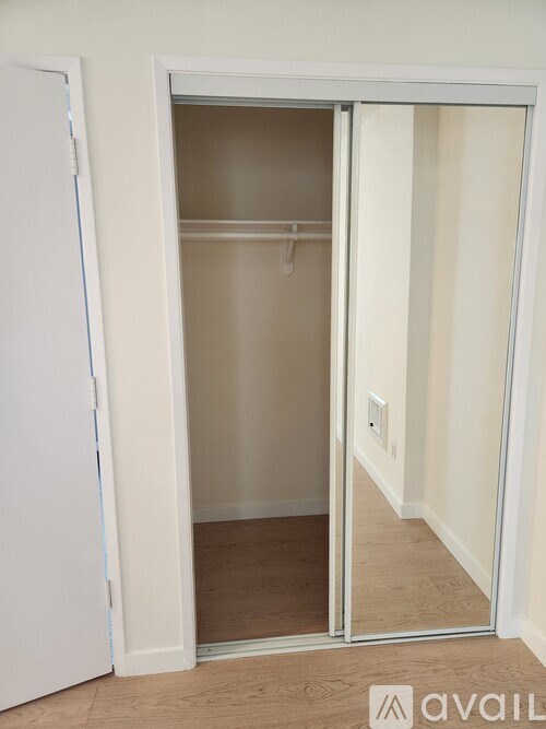 A white door with a glass panel is open.