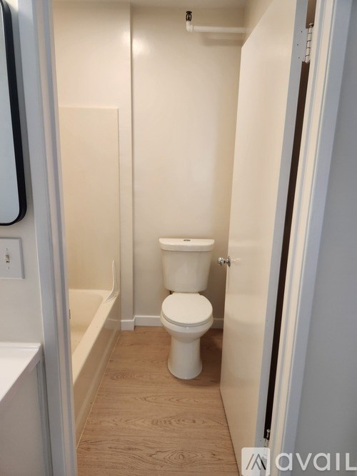 A white toilet in a small bathroom.