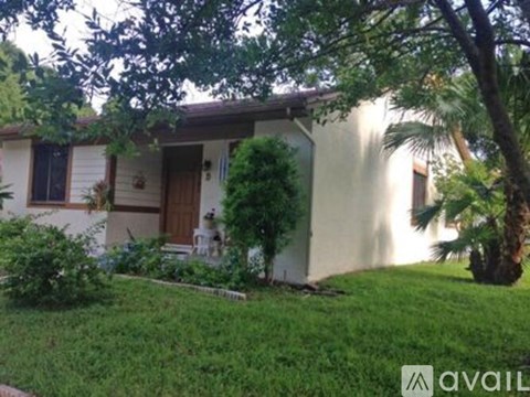 A house with a brown door and a small porch.