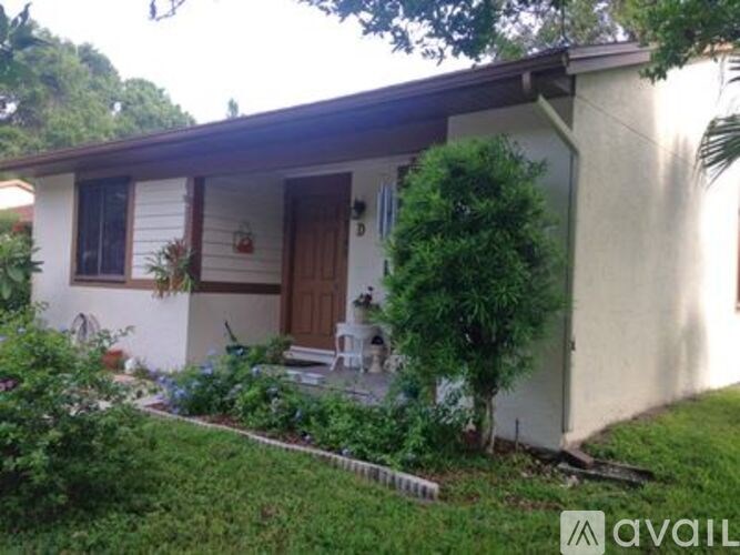A small house with a brown door and a brown roof.