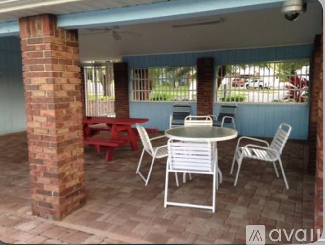 A patio with a table and chairs.