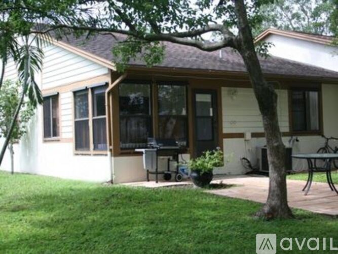 A house with a tree in front of it.