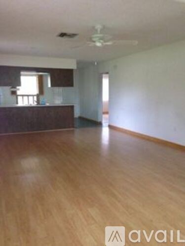 A room with wooden flooring and a window.