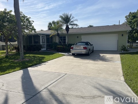 A house with a car parked in front of it.