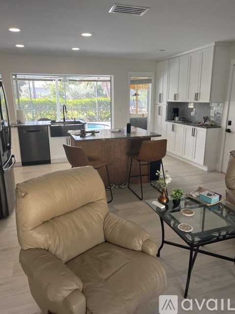 A modern kitchen with a dining table and chairs.