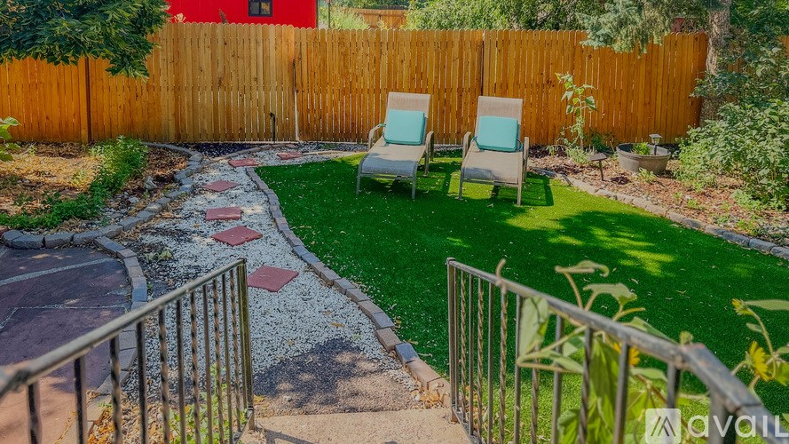 A backyard with a wooden fence and a small garden area.
