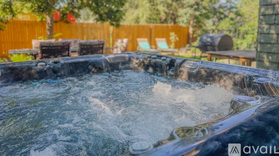 A hot tub with water splashing out of it.