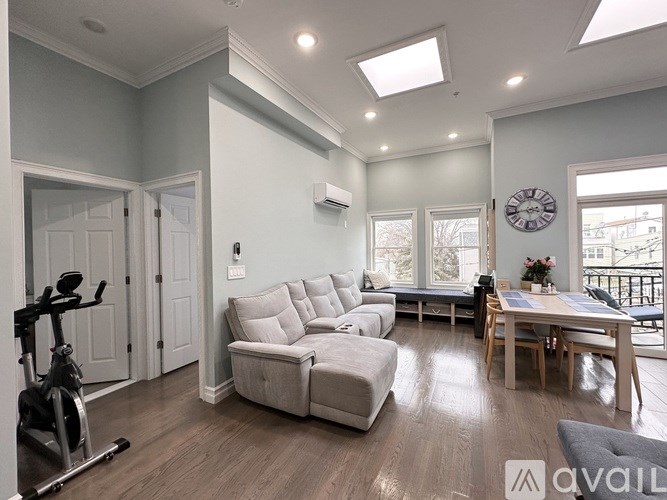 A living room with a grey couch and a wooden table.