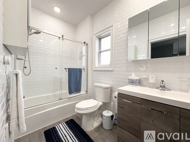 A bathroom with a toilet, sink, and bathtub.