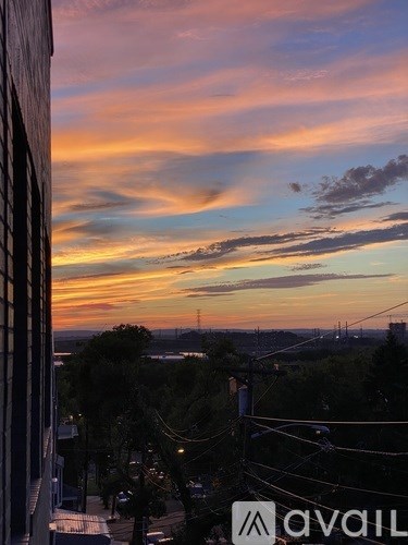 A view of a cityscape at sunset from a high vantage point.