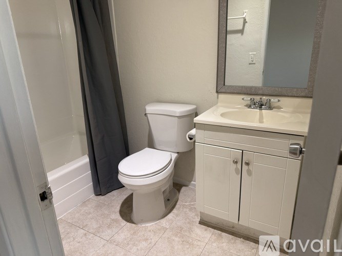 A white toilet sits next to a sink in a bathroom.