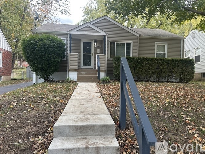 A house with a grey roof and a grey front door with a small porch.