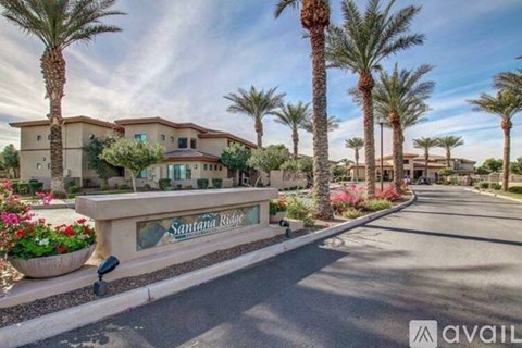 A street view of a residential area with palm trees and a sign that reads "Santana Ridge.".