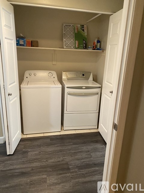 A small laundry room with a washer and dryer.