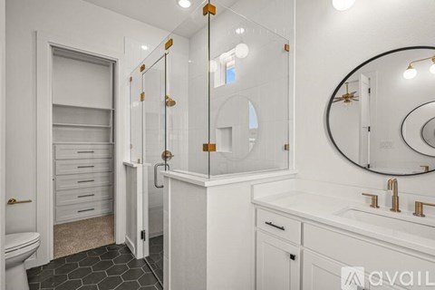 A bathroom with a white sink, mirror, and toiletries.