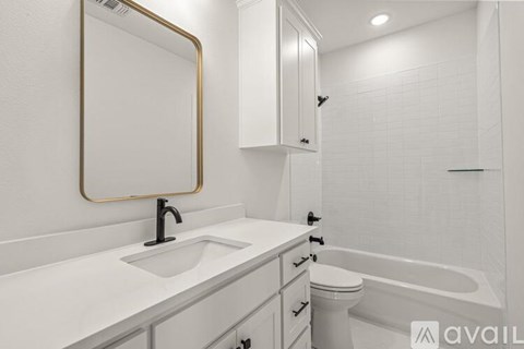 A bathroom with a sink, toilet, and bathtub.
