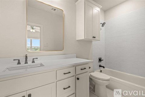 A bathroom with a white sink and toilet.