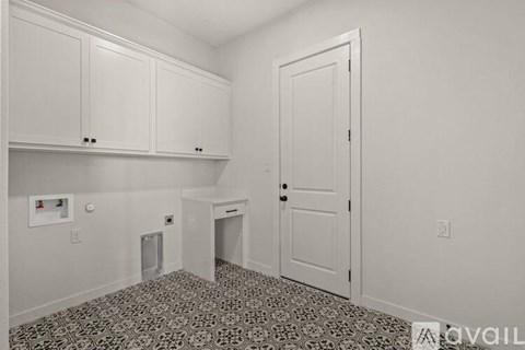 A room with a patterned floor and white walls.
