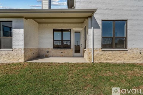 A house with a white brick exterior and a covered entrance.