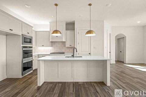 A modern kitchen with white cabinets and a center island.