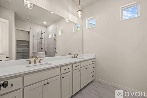 A bathroom with two sinks and a large mirror.