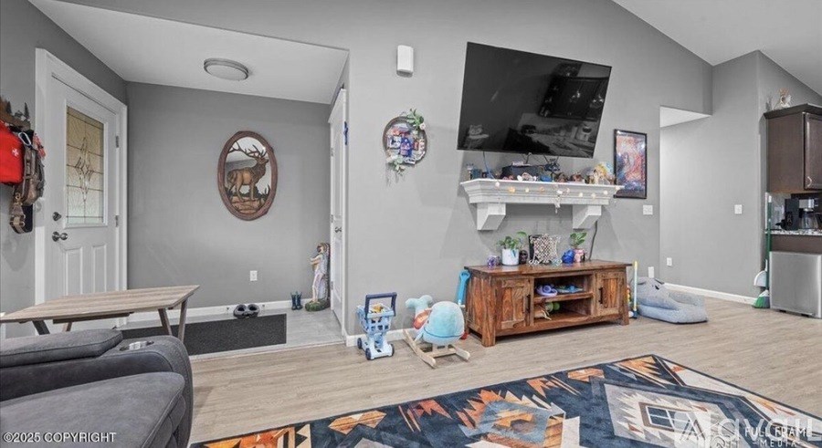 A living room with a grey couch and a rug with a mountain design on it.