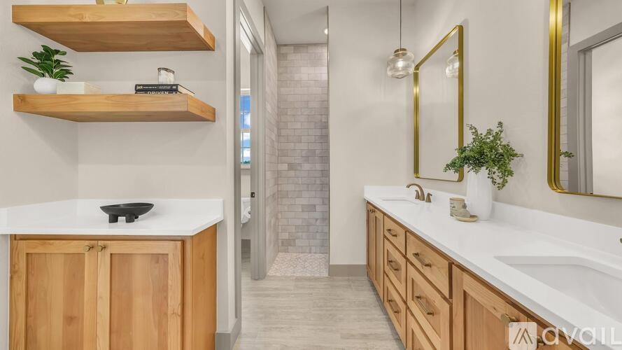 A bathroom with a white countertop and wooden cabinets.