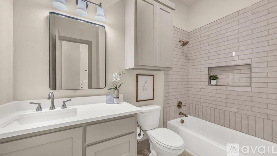 A bathroom with a white sink, toilet, and bathtub.
