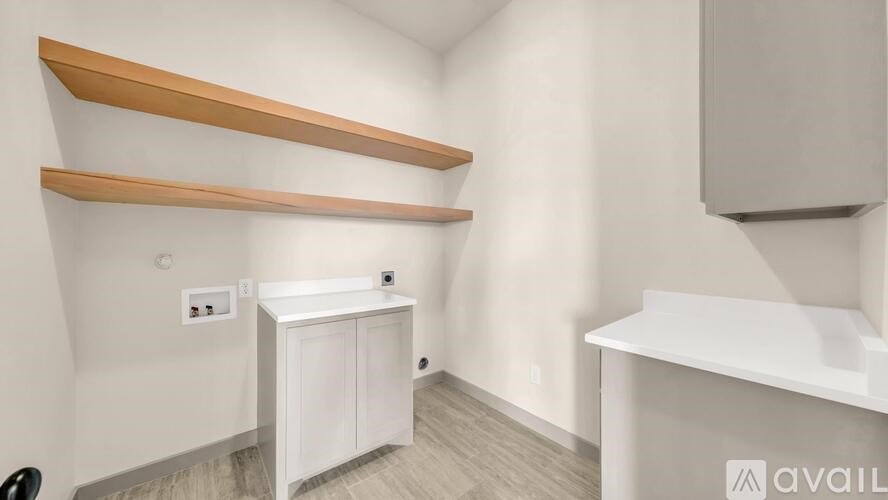 A white cabinet with a countertop and shelves above it.