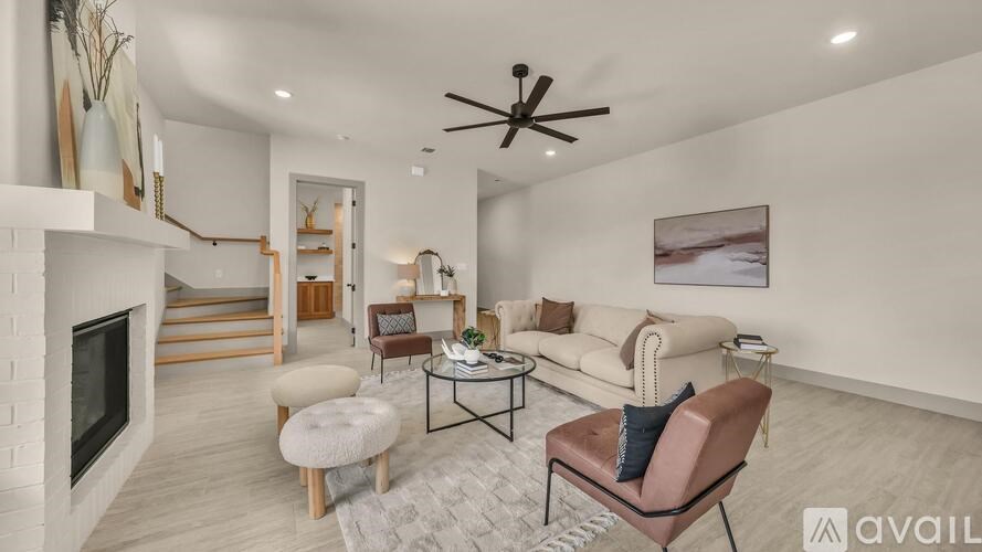 A living room with a fireplace, a sofa, a chair, and a coffee table.