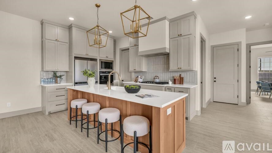A kitchen with a white countertop and bar stools.
