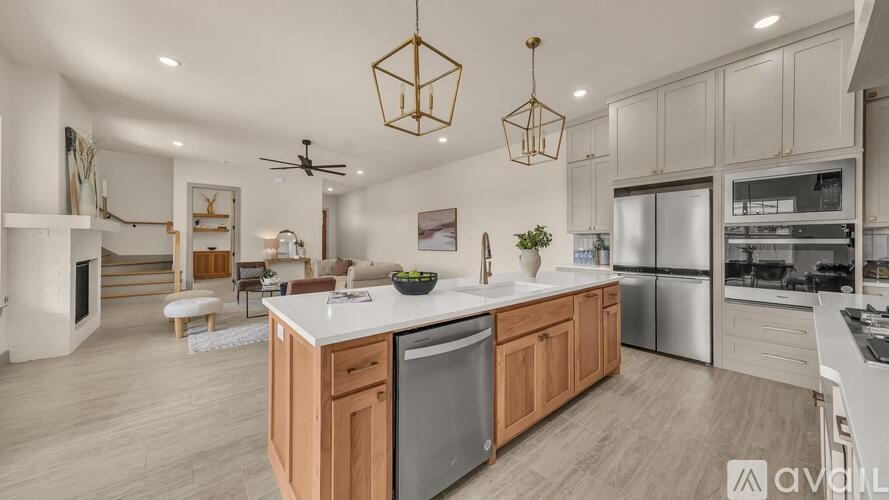 A modern kitchen with wooden cabinets and stainless steel appliances.