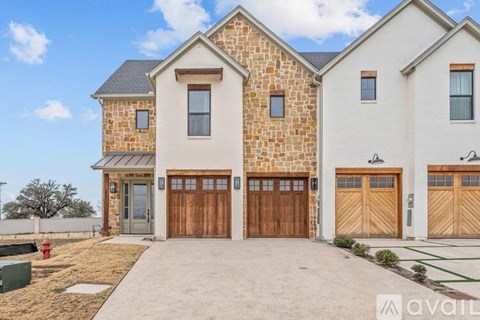 A house with a stone facade and a garage door.