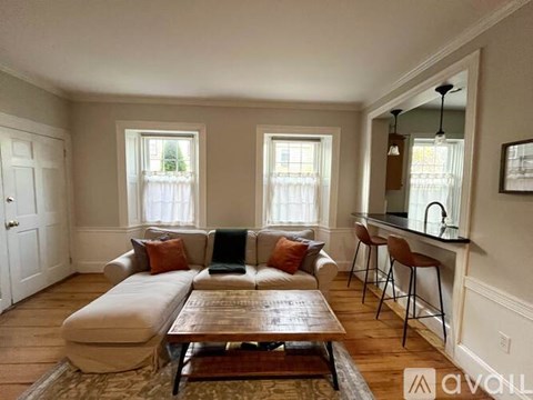 A living room with a couch, a coffee table, and a bar area.