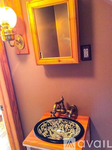 A bathroom with a mirror and a sink.