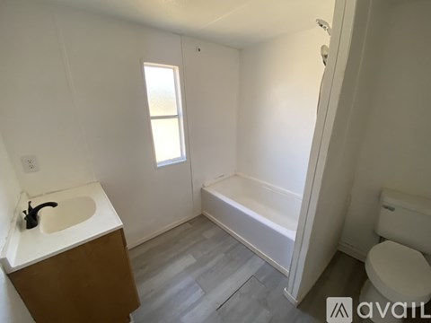 A bathroom with a sink, toilet, and bathtub.