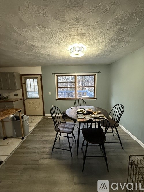 A dining room with a table set for four.