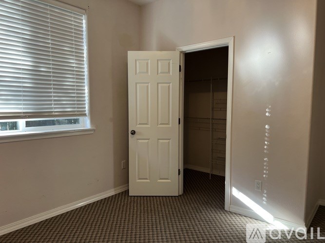 A white door is open to a hallway.